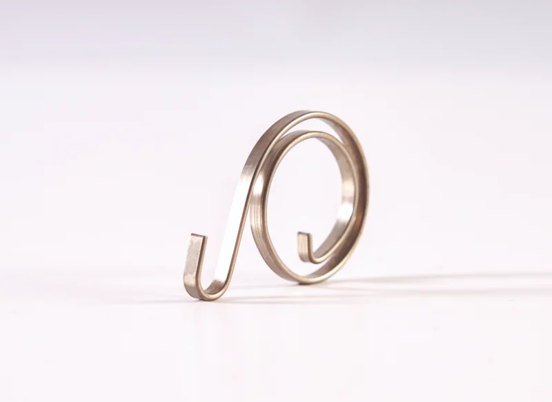 Conformado de fleje metálico en forma de espiral utilizado como componente elástico o de sujeción.